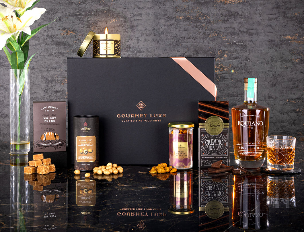 Lift your spirits with Exclusively Luxe's whisky gift hamper of fudge, nuts, chocolates and candle.
