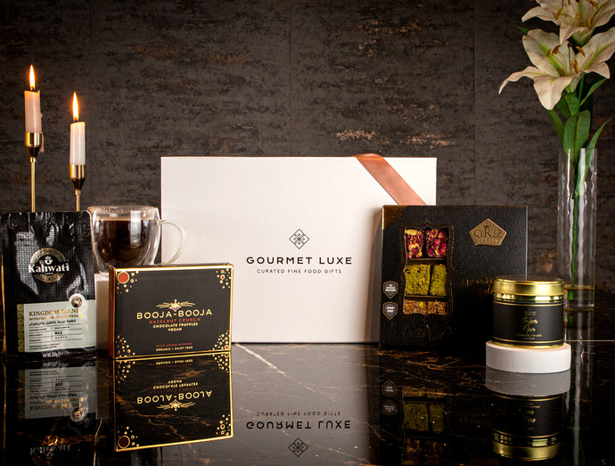 Elegant gift hamper by Exclusively Luxe with gourmet treats and candles